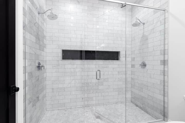 A large shower installation with white and grey tile for Tallahassee, Florida residence
